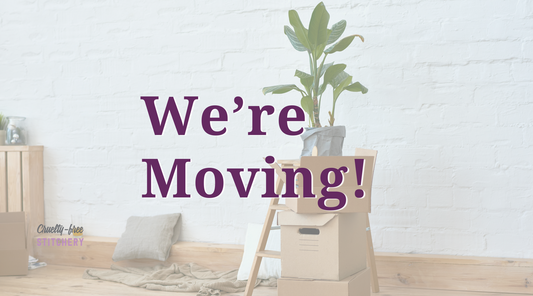 We're moving! Dark purple text over an image of some moving boxes and plants in an empty studio.