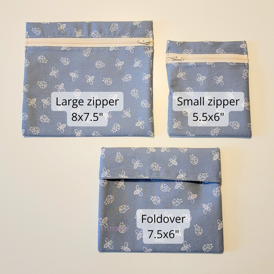 The different sizes of reusable snack bags, large zipper is 8x7.5", small zipper is 5.5x6", and fold-over is 7.5x6".