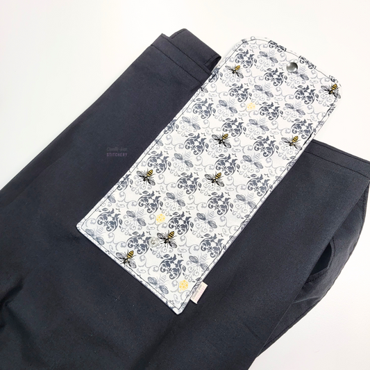 The opposite side of the foldable tote bag, with the bees and damask print flap in the center.