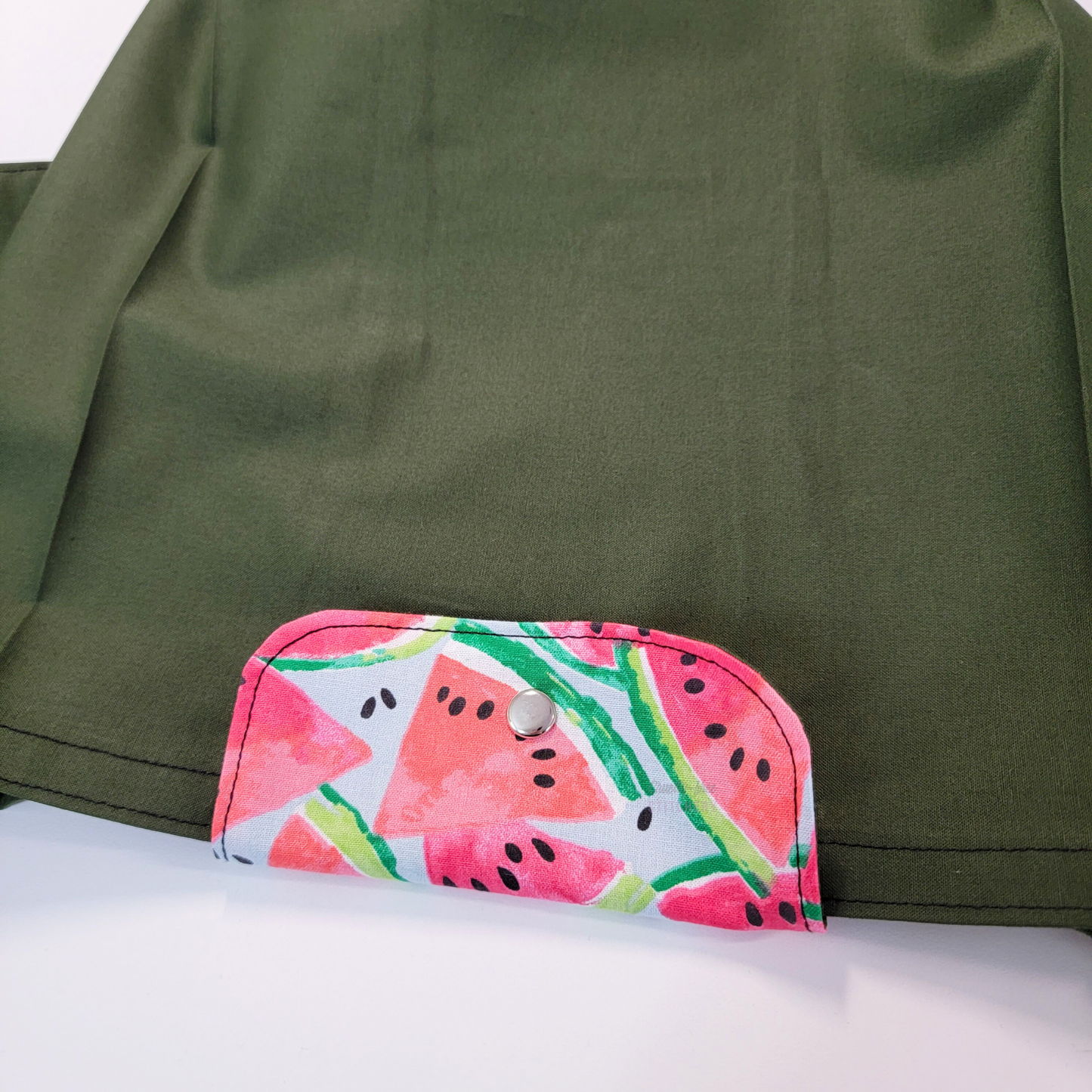 The flap also snaps to the top of the bag to close it while in use.