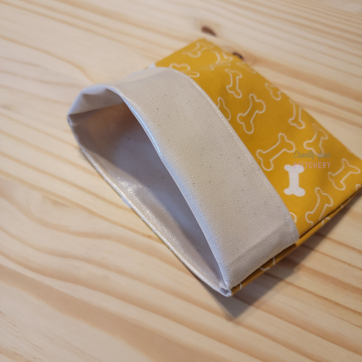 The fold-over snack bag with the top folded back, showing the lining.