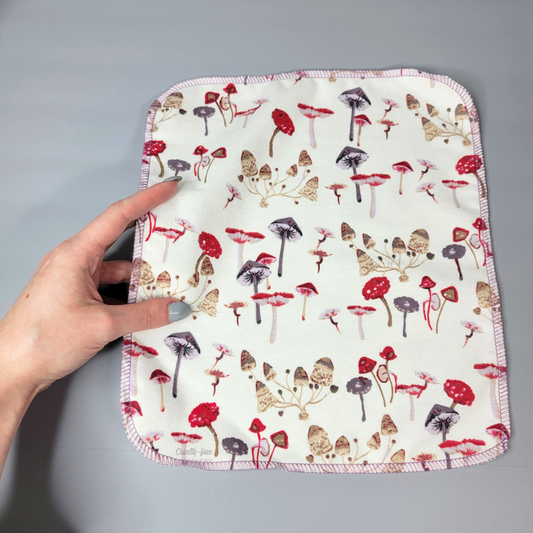 A mushrooms print NonPaper Towel being held in my hand for size reference.