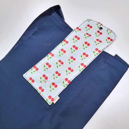 The opposite side of the foldable tote bag, with the cherry print flap in the center.