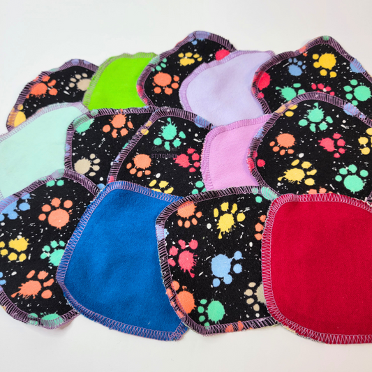 Paw print paint splatter cotton rounds arranged randomly to show more of the various back side colors, lime green, light aqua, pink, red, etc.