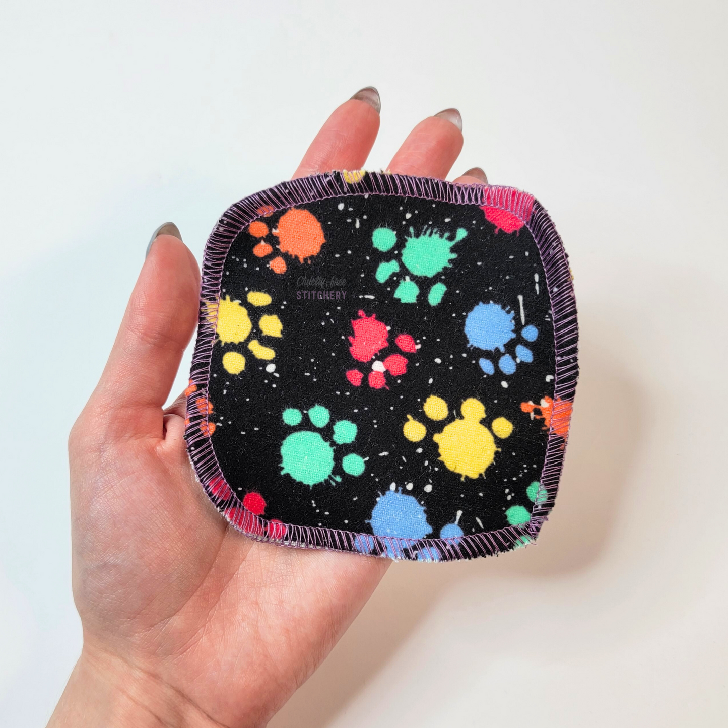 A single cotton round in my hand to show the relative size. They measure approximately 4 by 4 inches, a little bigger than the palm of my hand.