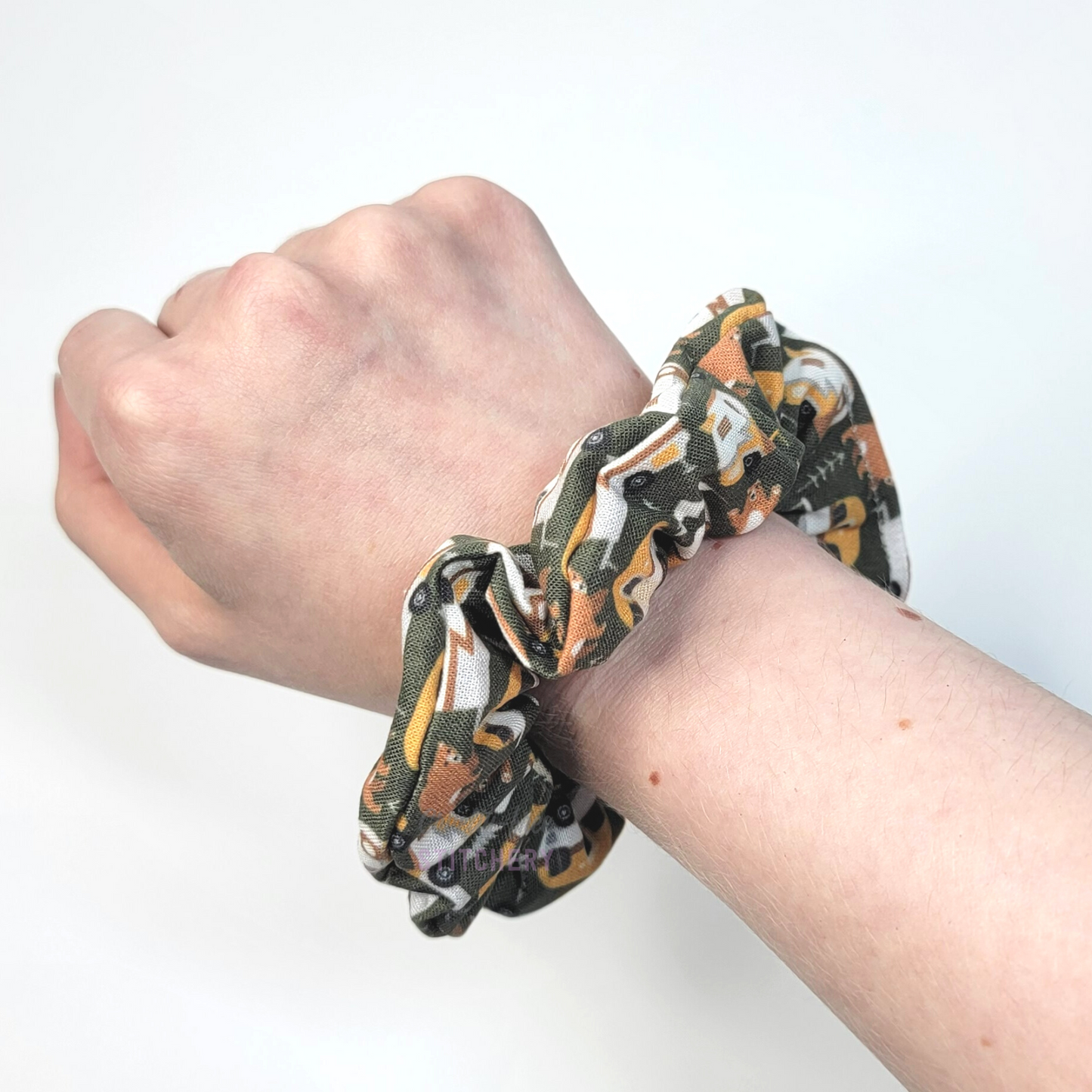 Scrunchie shown on my wrist for size reference. Fabric sticks out about an inch from the center of the scrunchie.