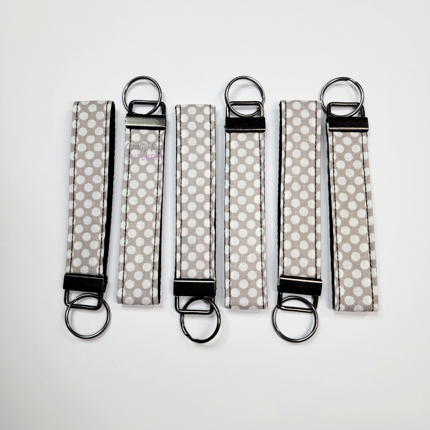 Wristlets arranged in a row to show each may be slightly different due to placement of the fabric.
