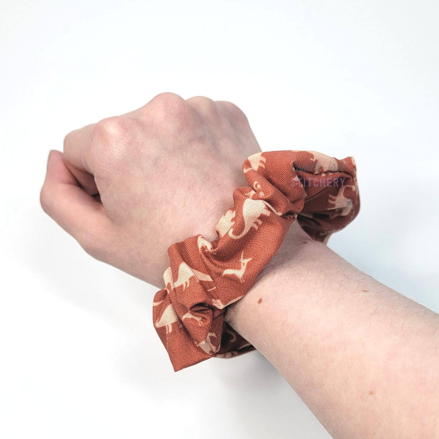 Scrunchie shown on my wrist for size reference. Fabric sticks out about an inch from the center of the scrunchie.