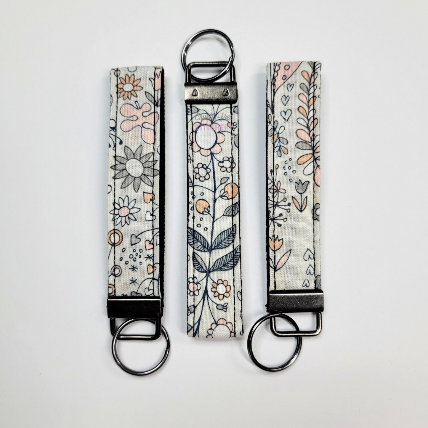 Wristlets arranged in a row to show each may be slightly different due to placement of the fabric.