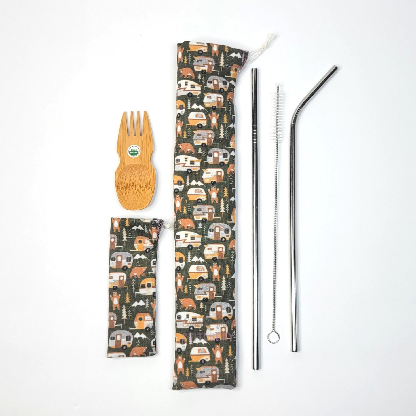 All contents of this bundle. A bamboo spork, campers print spork pouch, campers print straw pouch, and stainless steel straw set.