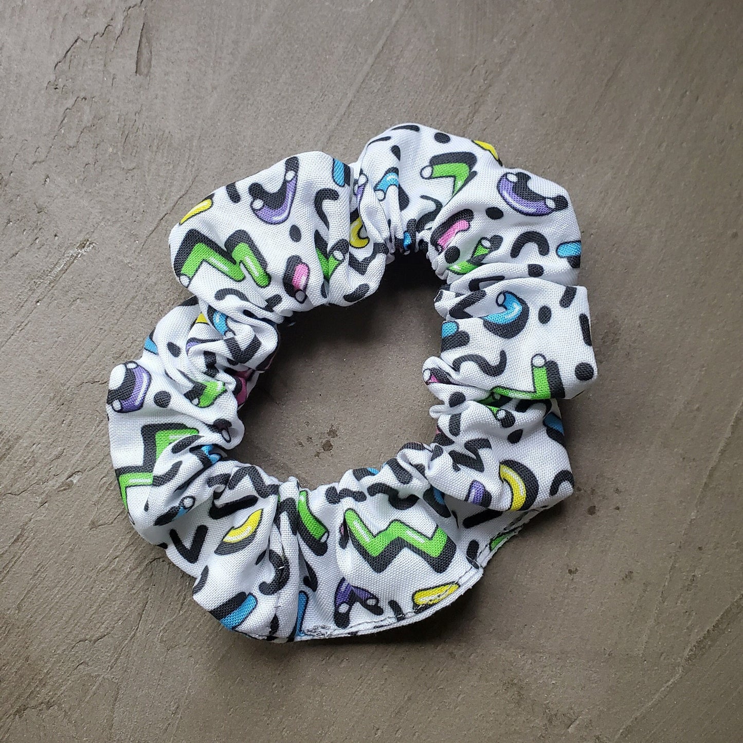 Scrunchie in natural sunlight on a concrete background.