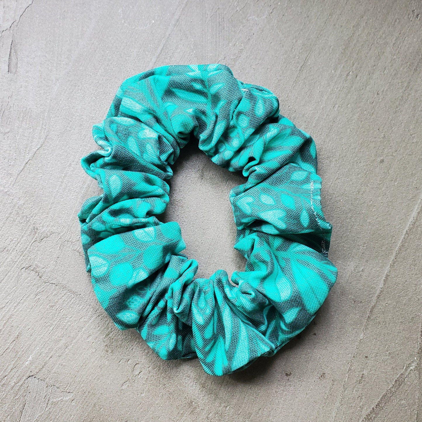 Scrunchie in natural sunlight on a concrete background.