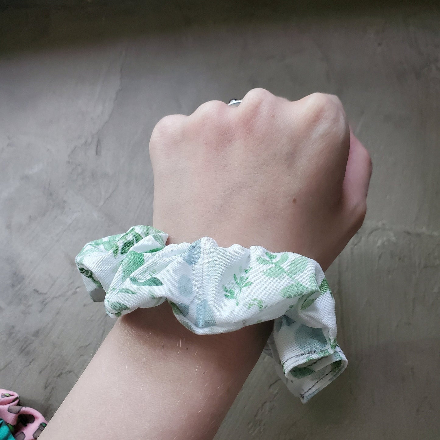 Scrunchie shown on my wrist for size reference. Fabric sticks out about an inch from the center of the scrunchie.