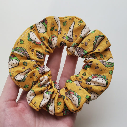 Taco print biodegradable scrunchie in my hand.