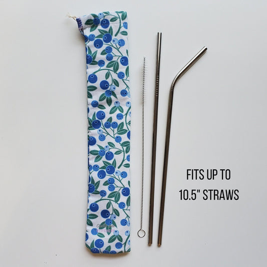 Reusable straw pouch in the same blueberry print laying vertically next to a straw cleaner brush, a straight stainless steel straw, and a bent stainless steel straw. Text reads "fits up to 10.5 inch straws"