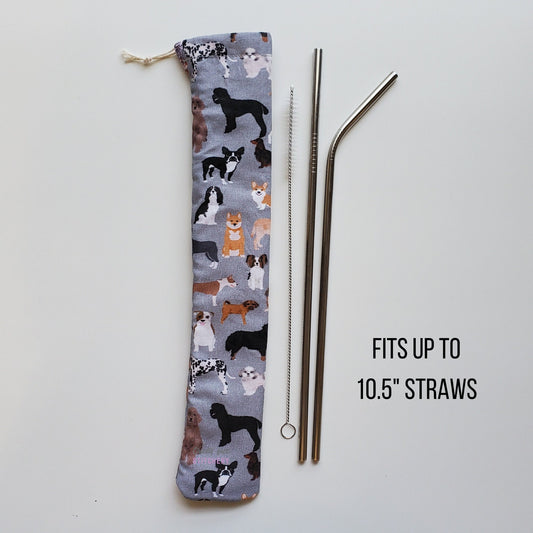 Reusable straw pouch in the same dog print laying vertically next to a straw cleaner brush, a straight stainless steel straw, and a bent stainless steel straw. Text reads "fits up to 10.5 inch straws"