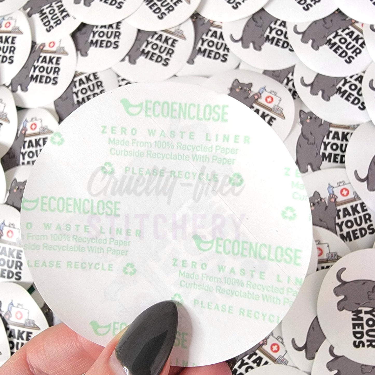 The back of the "take your meds" sticker, shows the EcoEnclose branding with text that says "zero waste liner, made from 100% recycled paper, curbside recyclable with paper, please recycle."