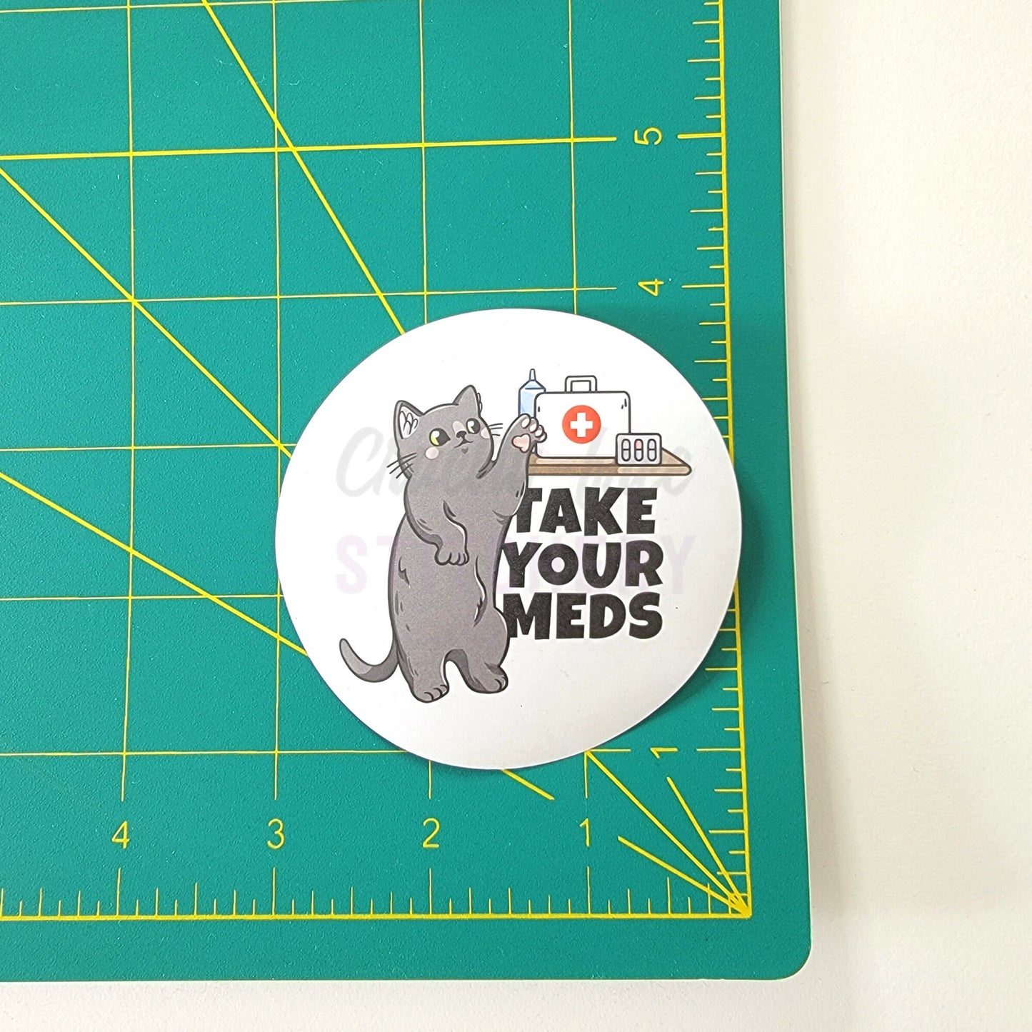 The "take your meds" sticker on a ruler, it is a 3 inch wide circle.