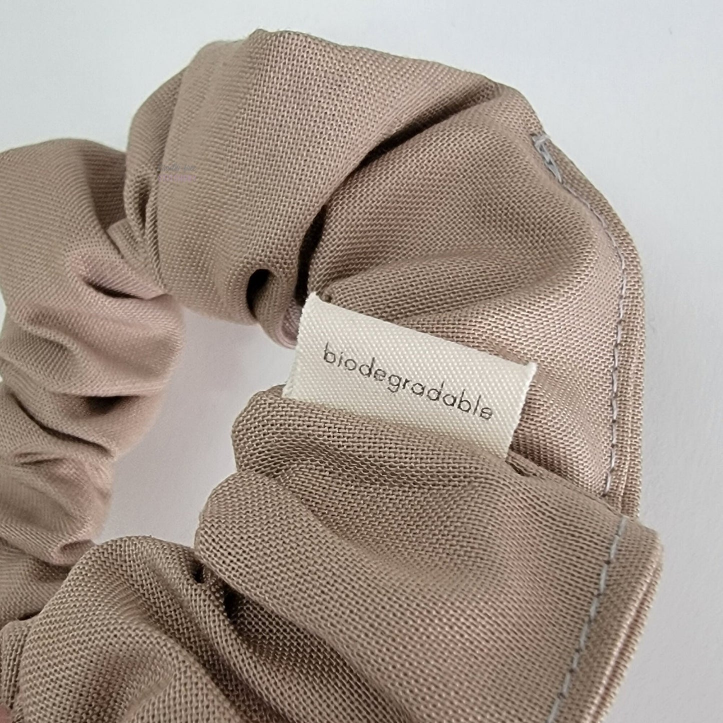 The back of the small white tag says "biodegradable"