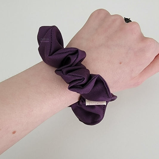 Scrunchie shown on my wrist for size reference. Fabric sticks out about an inch from the center of the scrunchie.