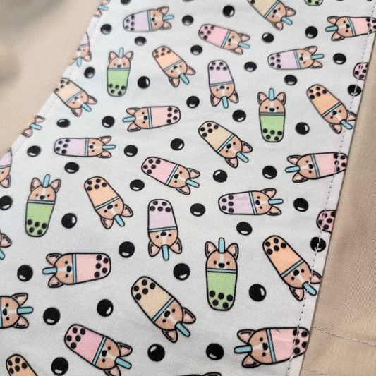 A close-up of the boba print. The cups are mint green, light pink, and light peach, and there are tapioca pearls scattered around.