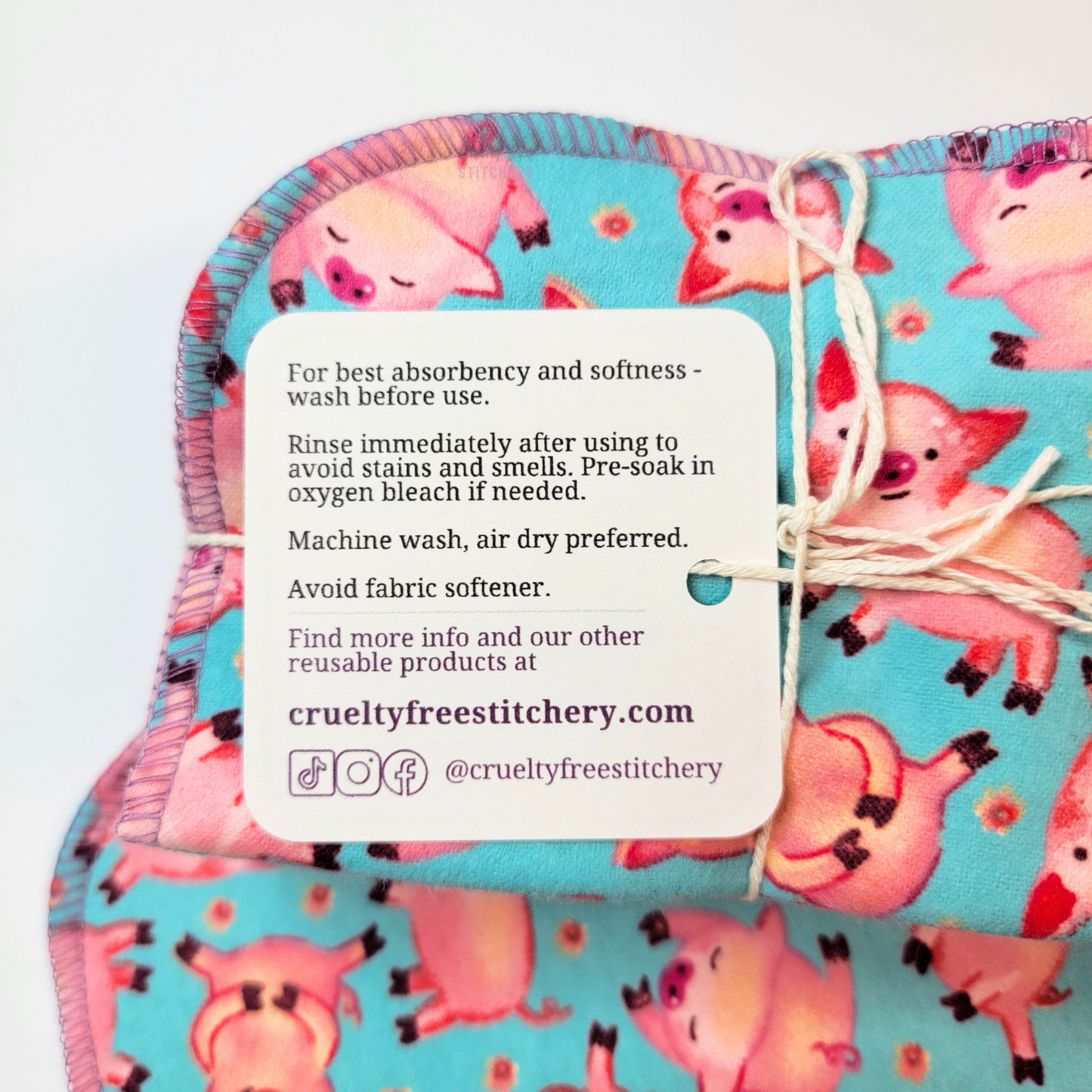 The back of the cloth wipes tag with care instructions and our shop info.