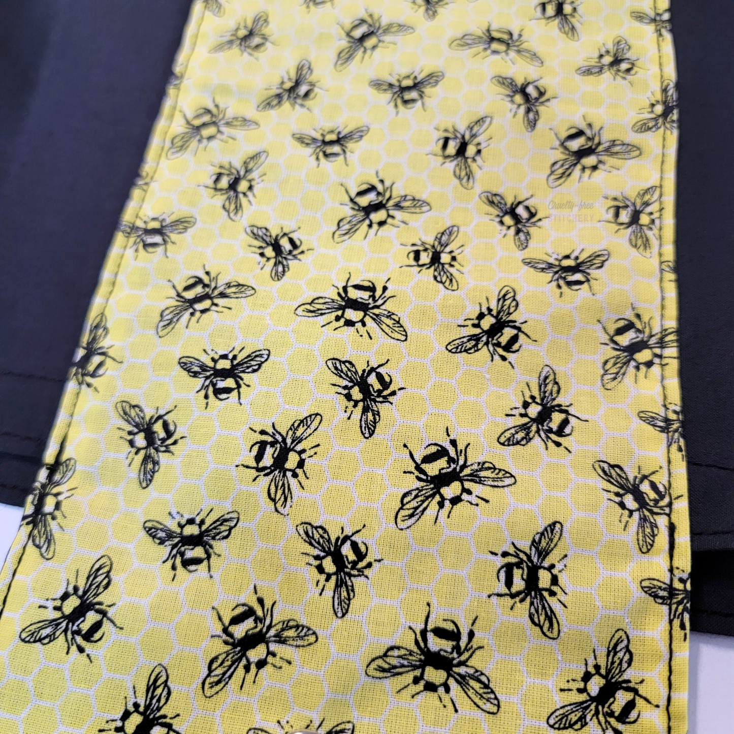 A close-up of the bee print, showing that there is a subtle honeycomb pattern in the background.