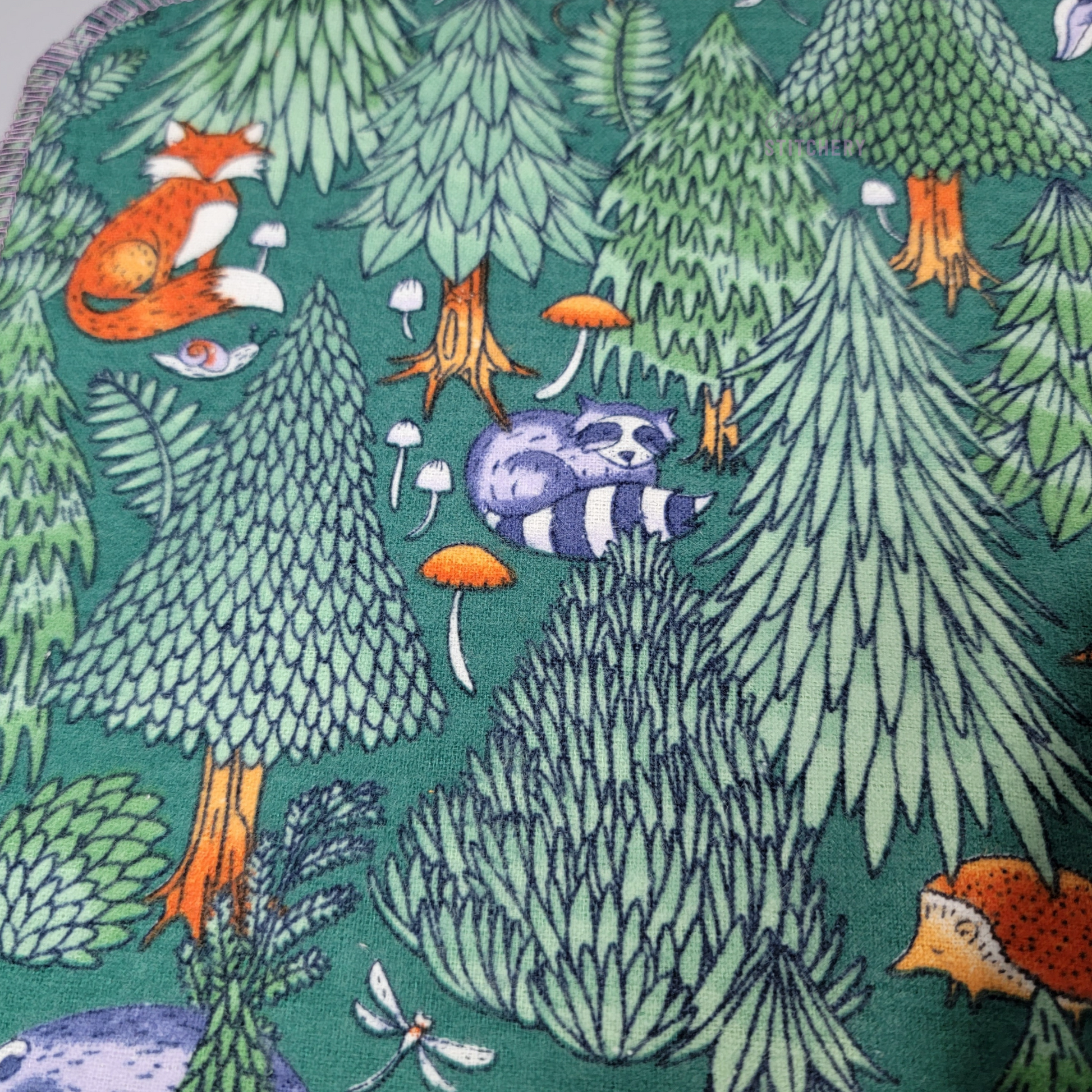Close-up of the print, showing a fox, raccoon, and hedgehog.