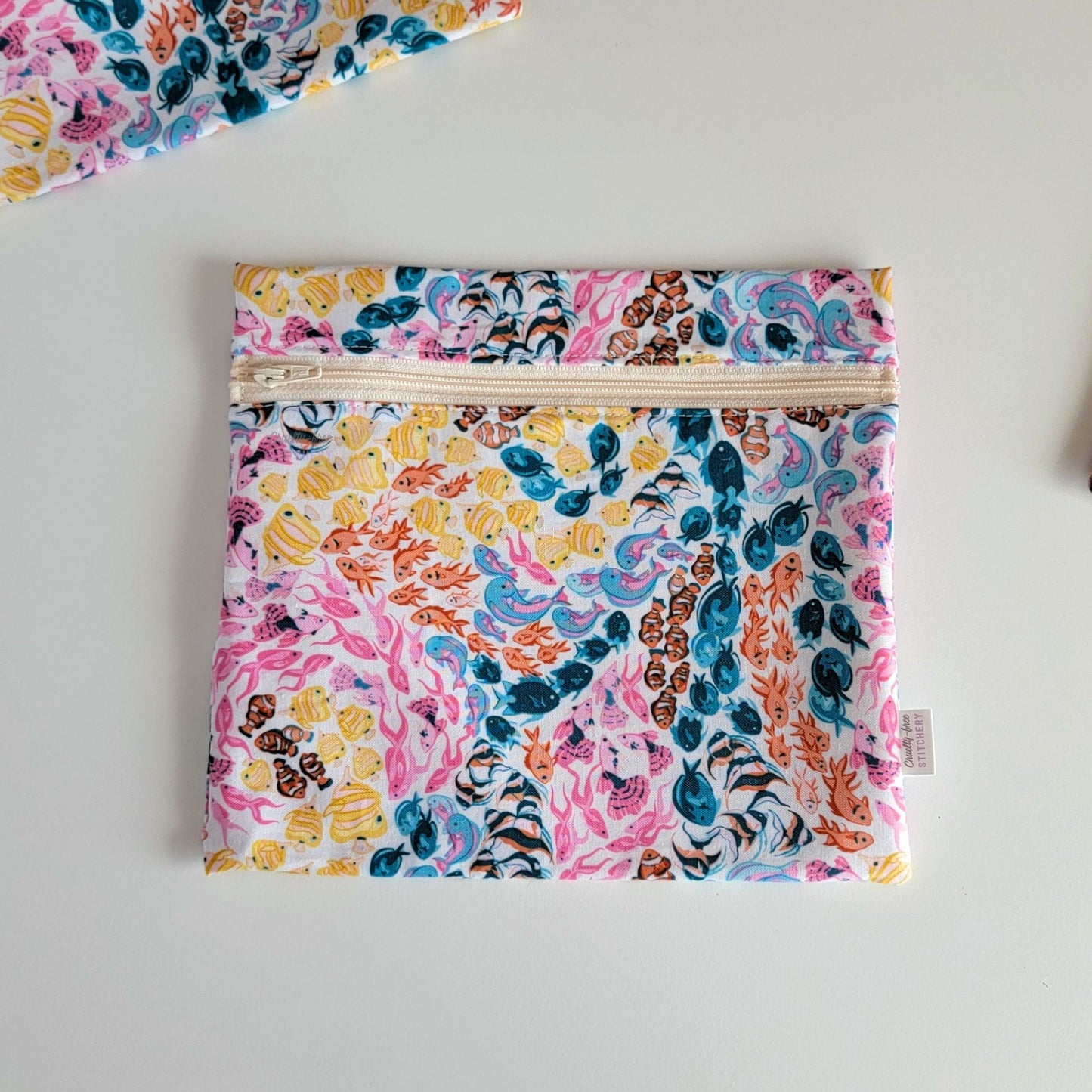 The colorful reef Large Zip Reusable Snack Bag, shown closed with two other bags barely visible on the edges of the photo. 