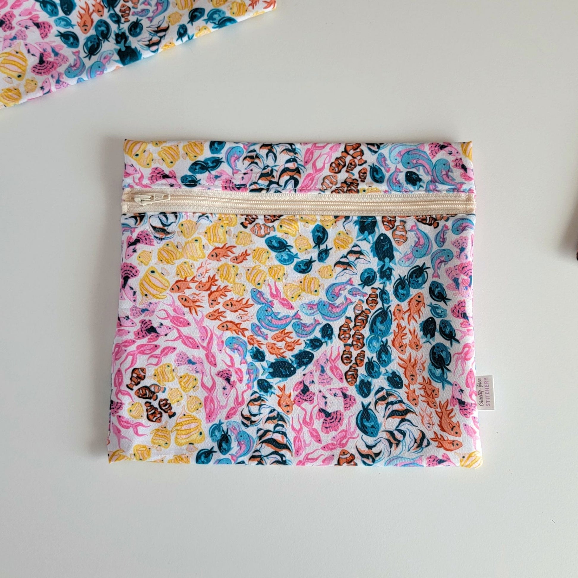 The colorful reef Large Zip Reusable Snack Bag, shown closed with two other bags barely visible on the edges of the photo. 