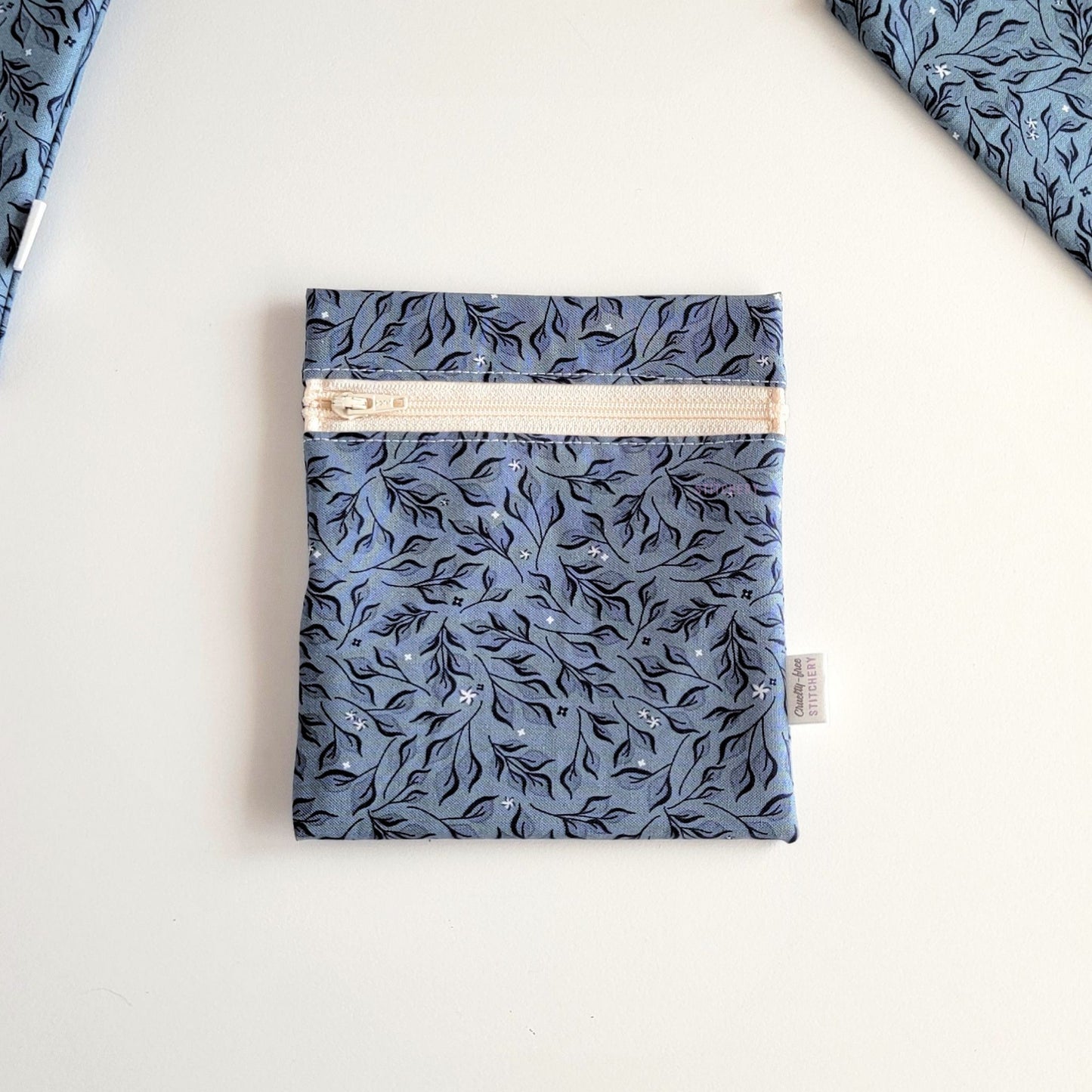 The Stone Leaves Small Zip Reusable Snack Bag, shown closed with two other bags barely visible on the edges of the photo. 