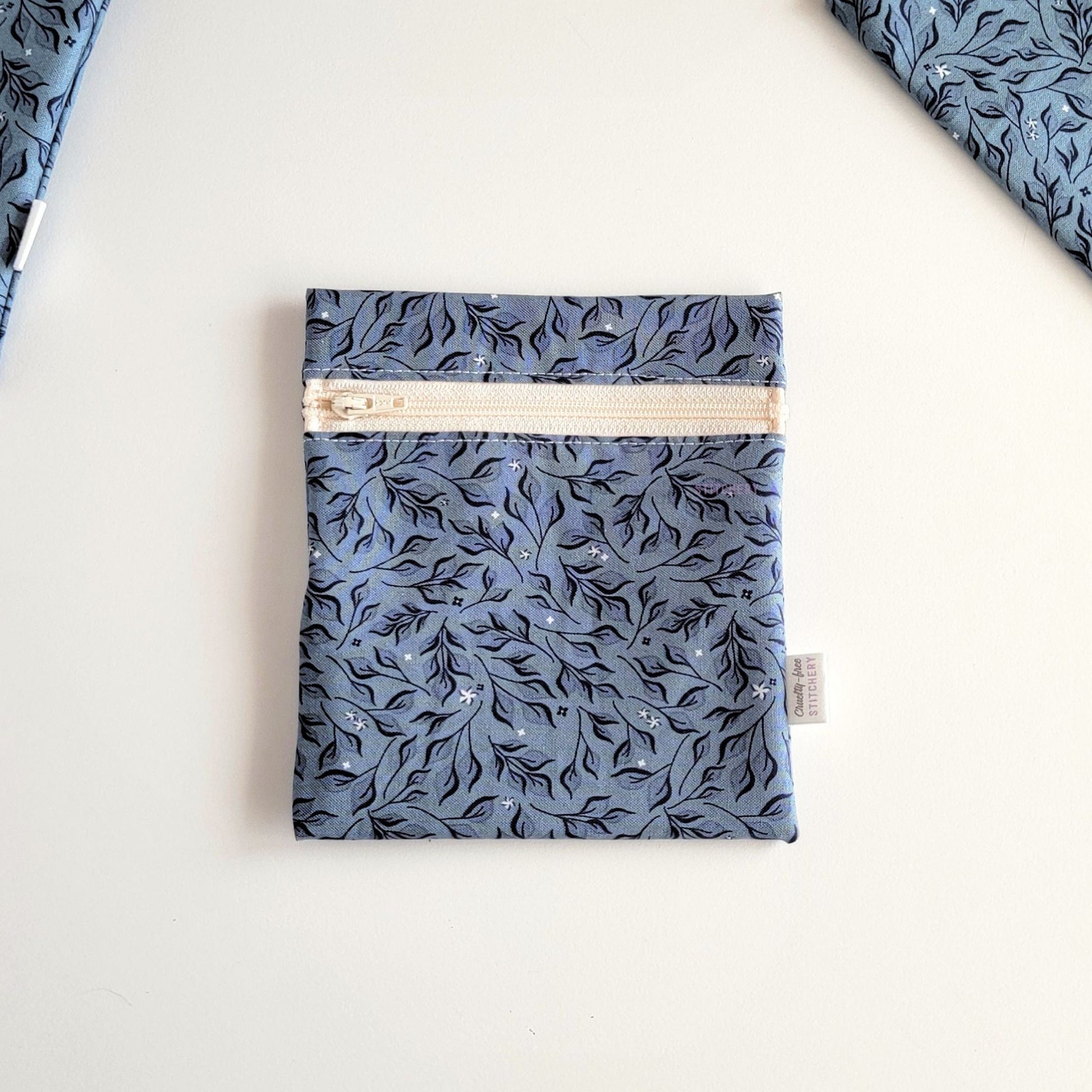 The Stone Leaves Small Zip Reusable Snack Bag, shown closed with two other bags barely visible on the edges of the photo. 