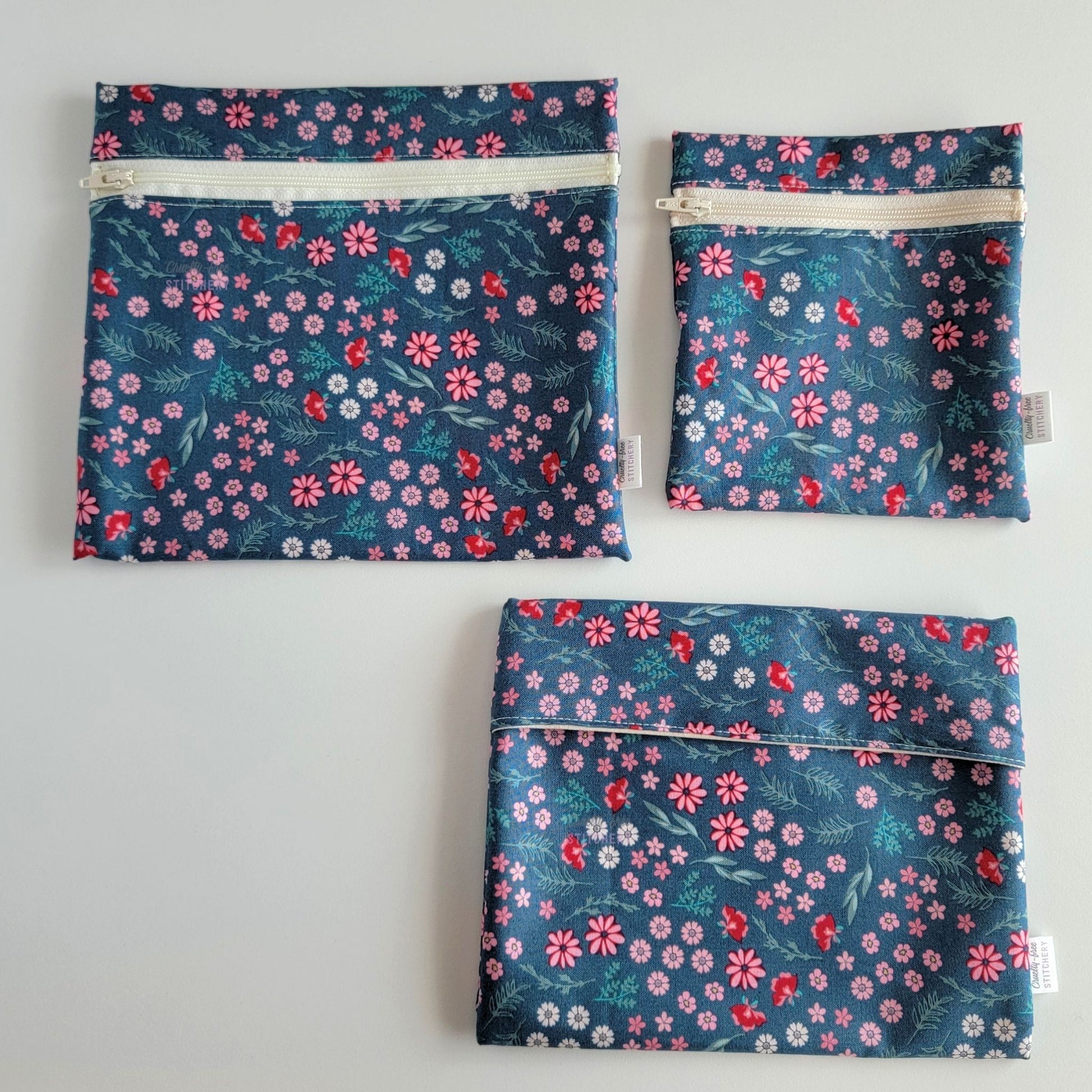Three Teal Pink Floral Reusable Snack Bags arranged separately to show the difference between sizes. Large Zip is not quite double the size of the Small Zip, and the Foldover is slightly smaller than the Large Zip.