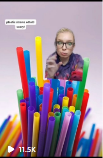 Screenshot from an Instagram reel, a photo of a bundle of colorful plastic straws, with Abby's floating torso and text that says "plastic straws ooo scary!"