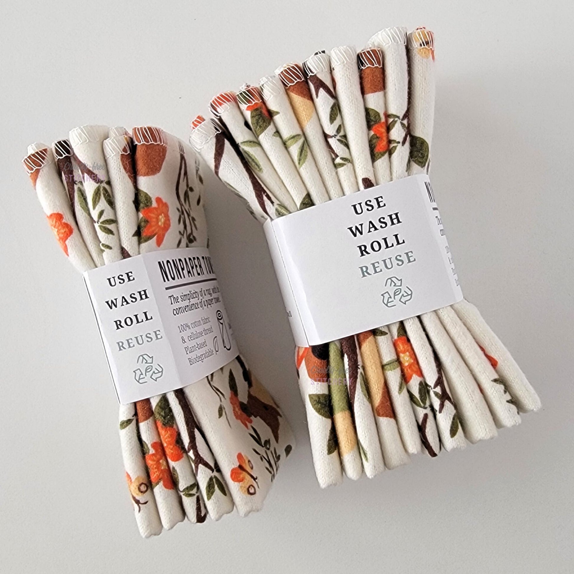 Two packages of the Ivory Foxes NonPaper Towels, shown on their side to display the 5-pack and 10-packs. The side of the paper tag says "use, wash, roll, reuse" and has the recycling logo with a leaf in the center, to symbolize they are biodegradable.