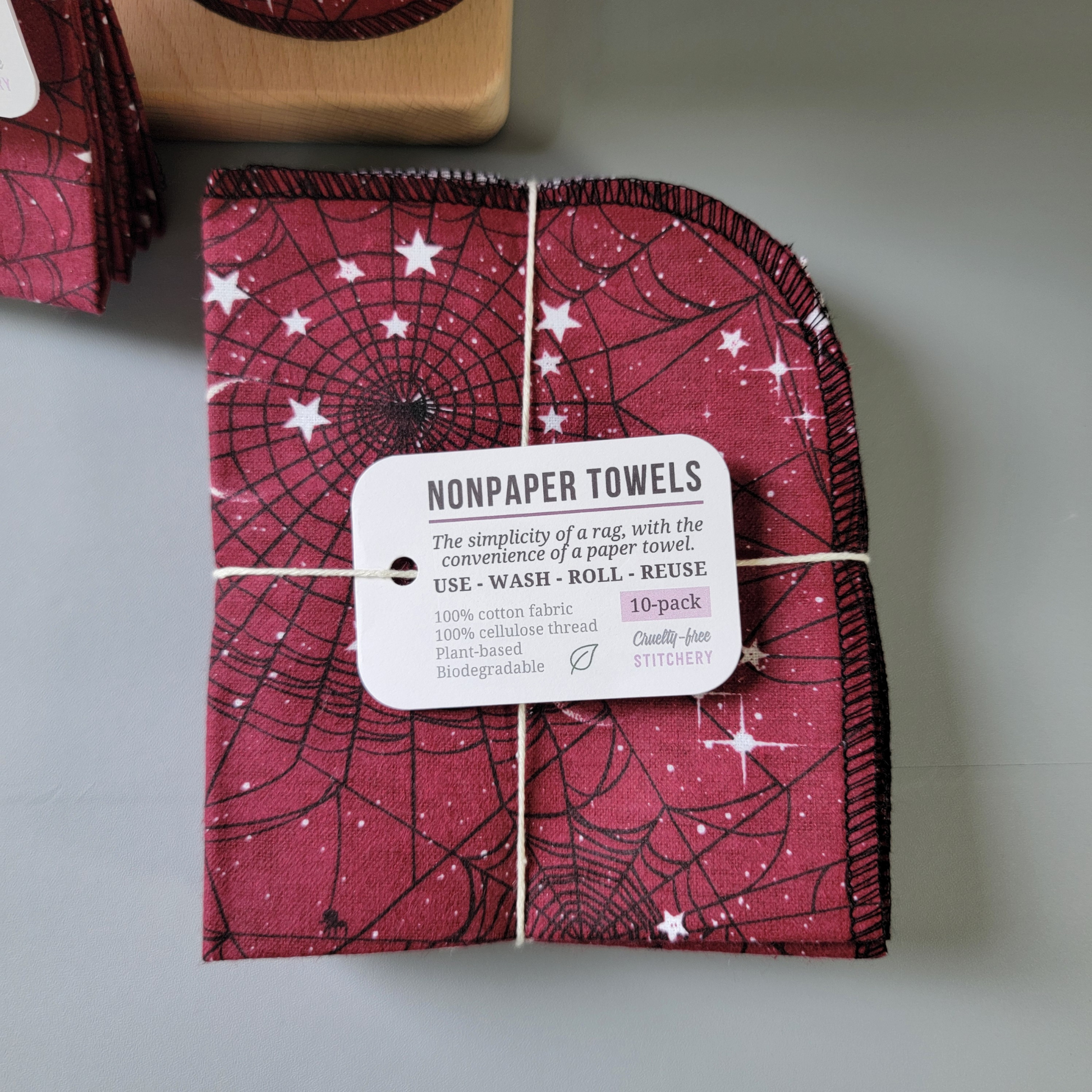 A bundled 10-pack of the red moon web nonpaper towels, close-up. Same tag as the 5-pack, but it of course says 10-pack instead. 