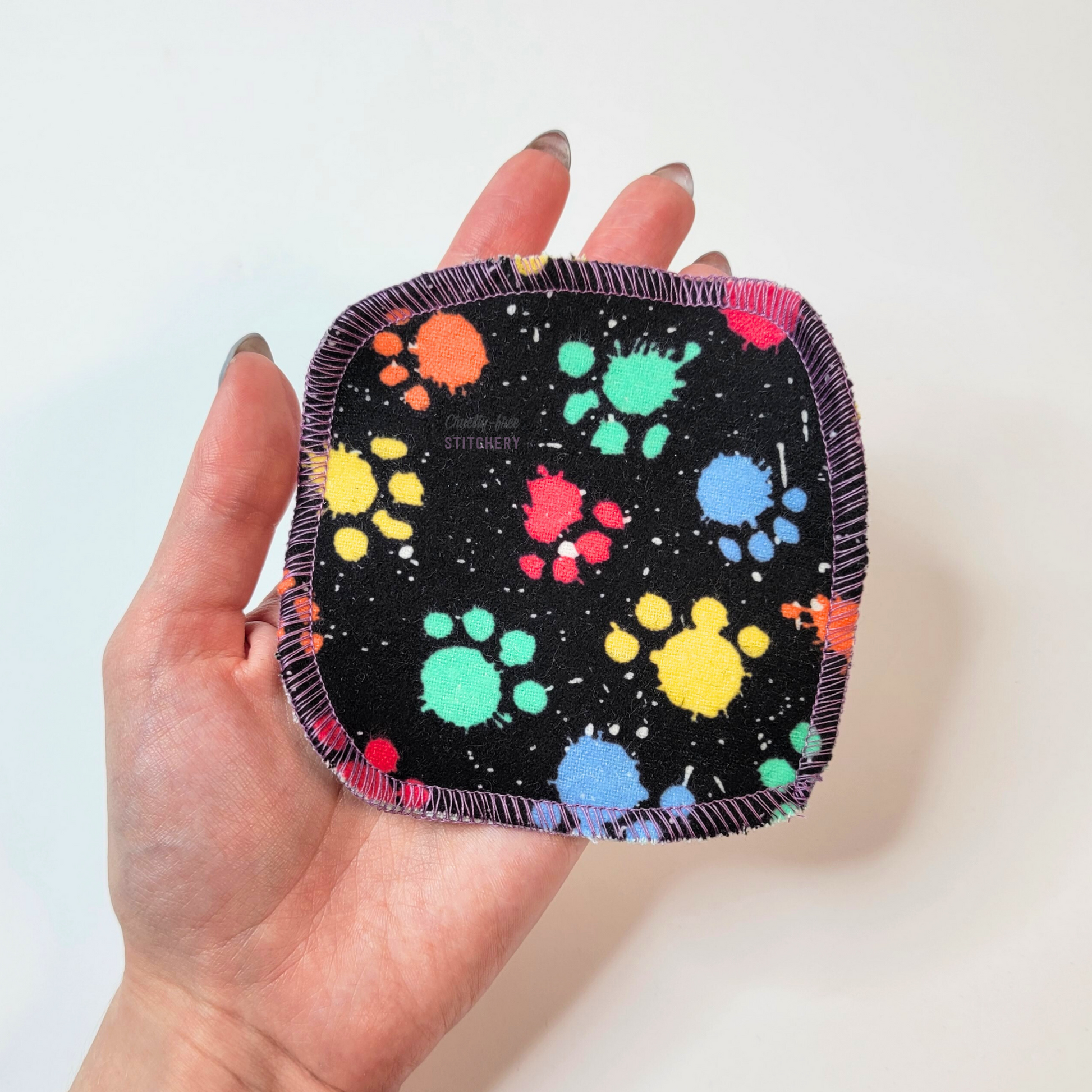 A single cotton round in my hand to show the relative size. They measure approximately 4 by 4 inches, a little bigger than the palm of my hand.