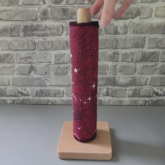pulling a nonpaper towel off the roll and showing it close-up