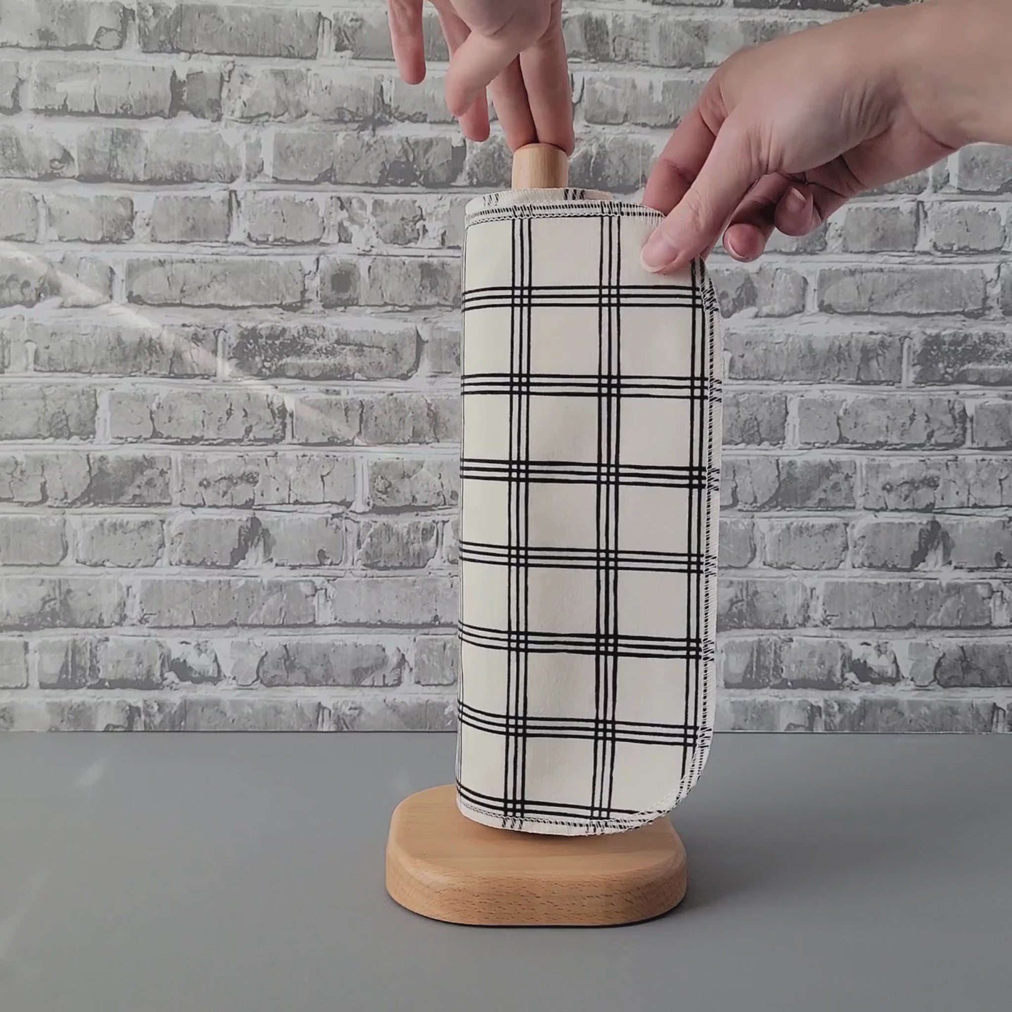 Unrolling an Ivory Black Crossroad NonPaper Towel.