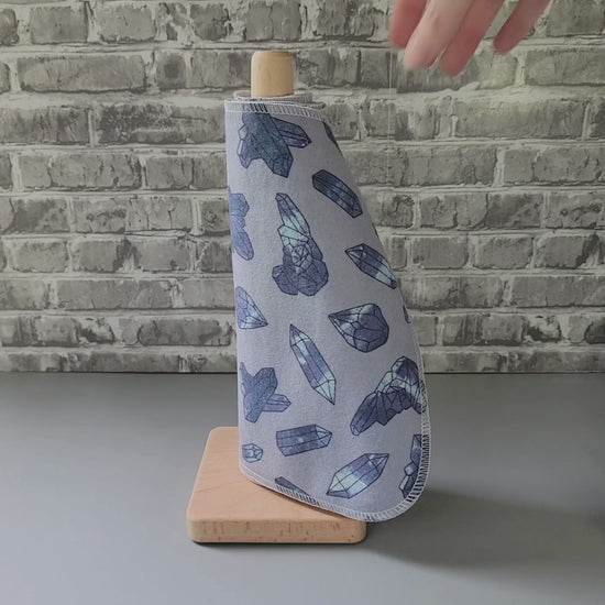pulling a nonpaper towel off the roll and showing it close-up