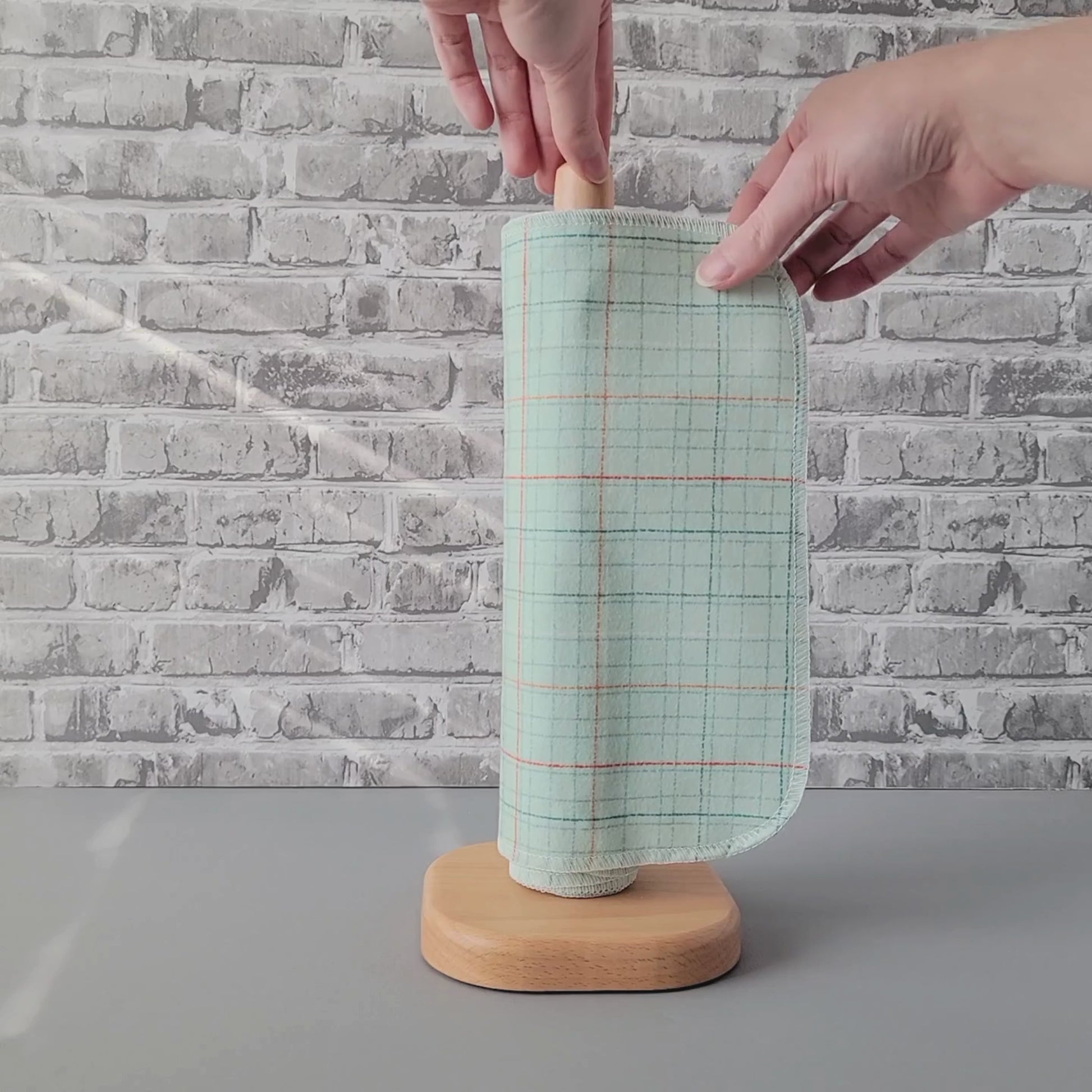 Unrolling a Pale Blue Grid NonPaper Towel.