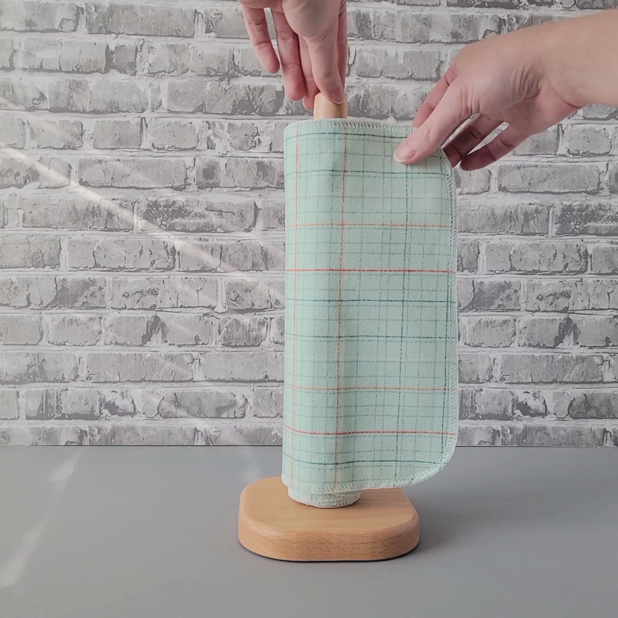 Unrolling a Pale Blue Grid NonPaper Towel.