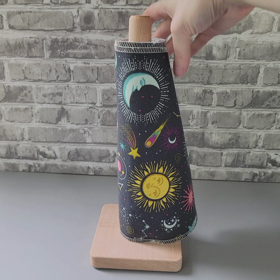 pulling a nonpaper towel off the roll and showing it close-up