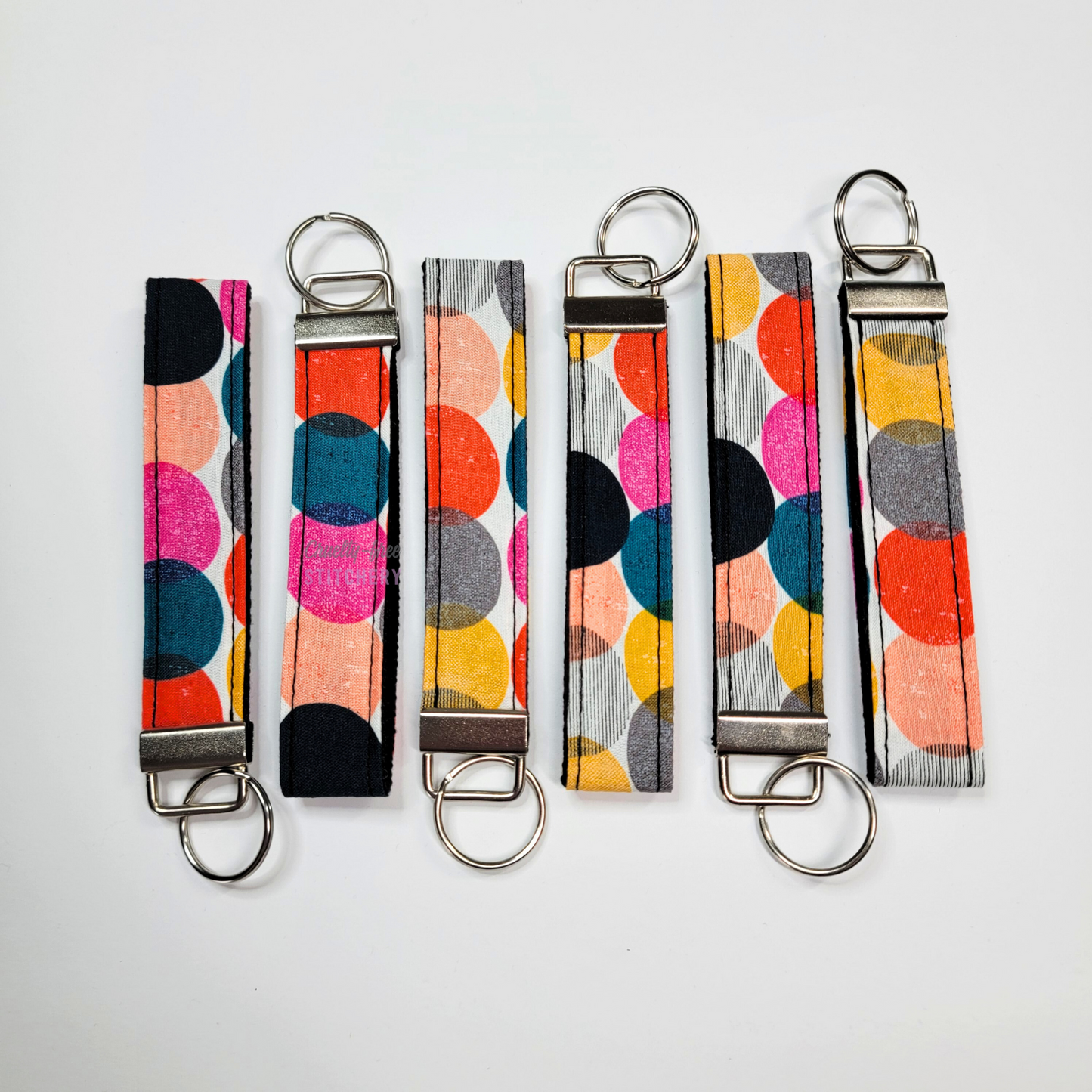Wristlets arranged in a row to show each may be slightly different due to placement of the fabric.