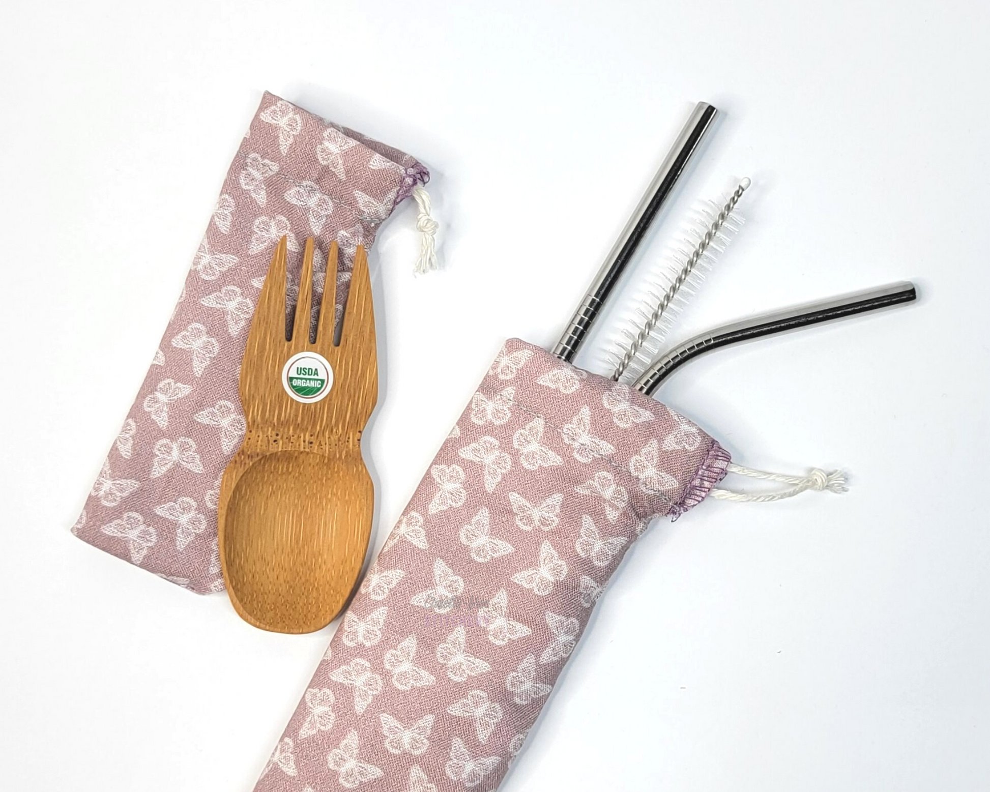 Reusable bamboo spork and stainless steel straw pouch set. The pouches are both a light mauve pink with tiny white butterflies.