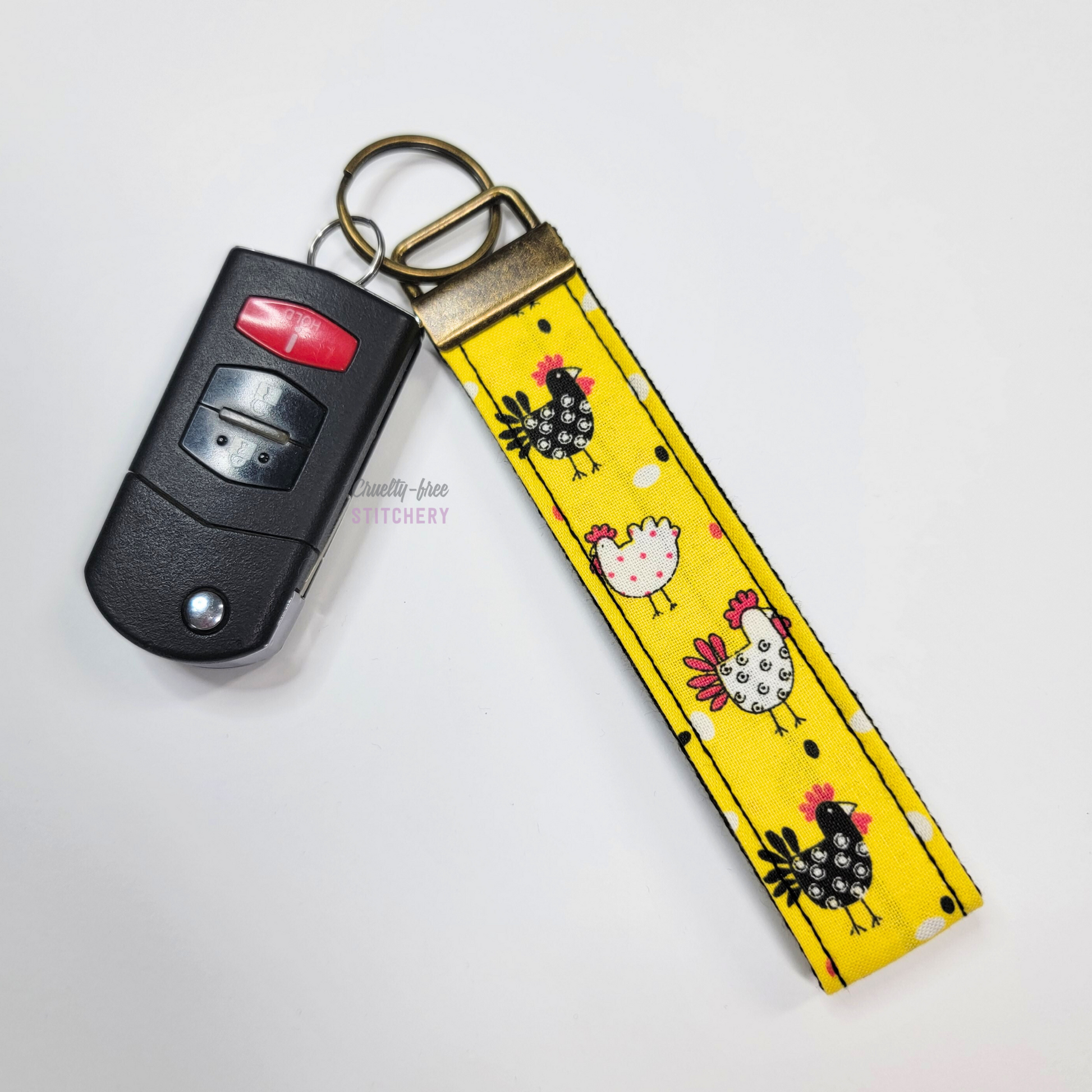 The yellow chickens key fob attached to a car key.