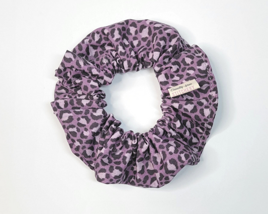 A muted violet purple leopard print scrunchie.