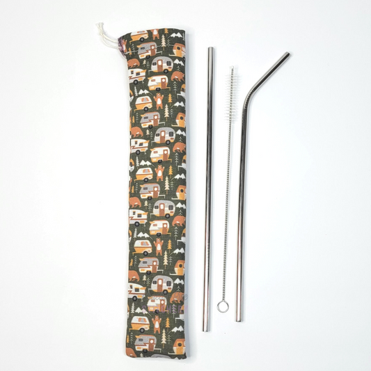 Reusable straw pouch in the same campers print laying vertically next to a straw cleaner brush, a straight stainless steel straw, and a bent stainless steel straw.