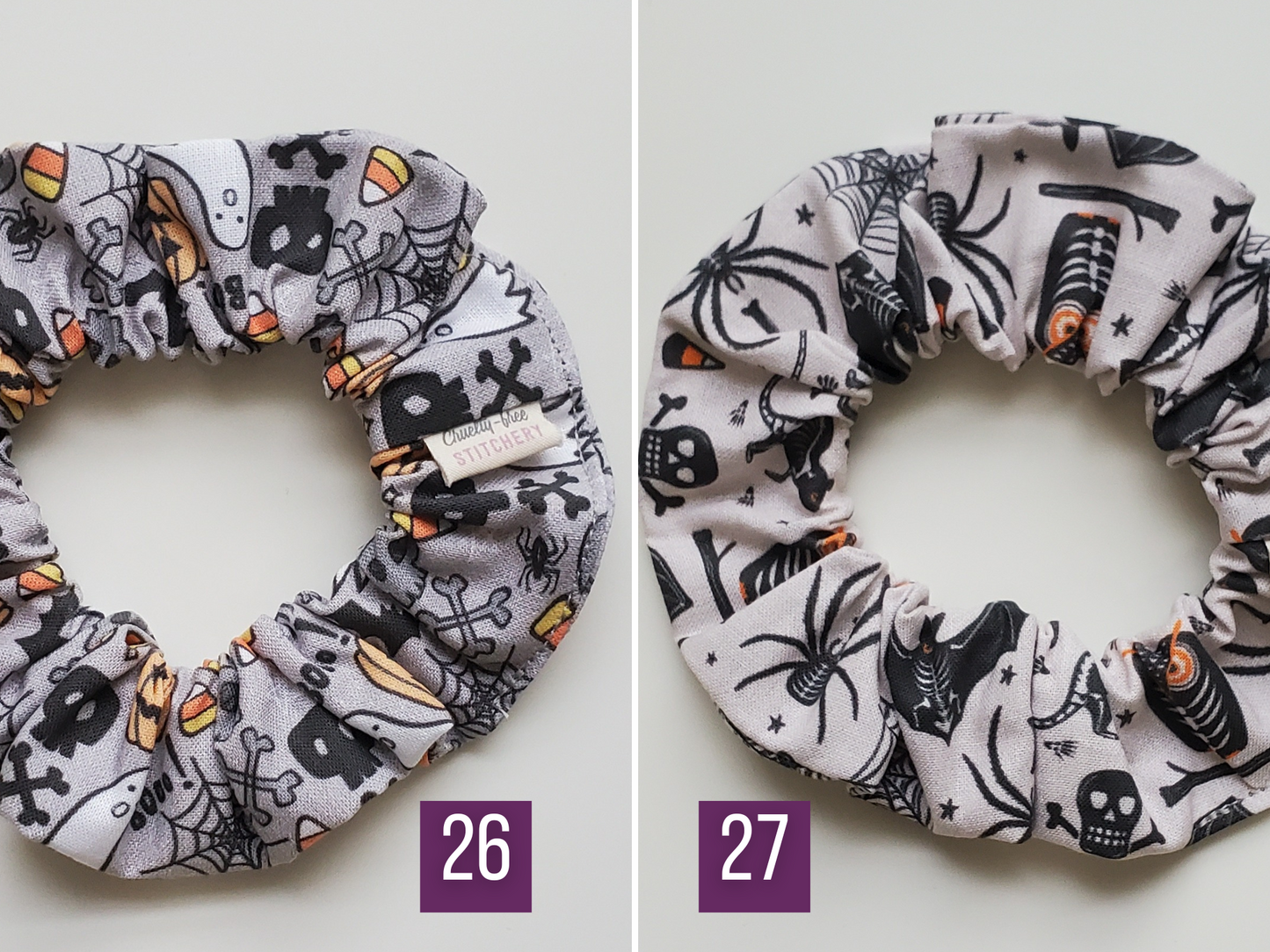 Comparison of prints 26 and 27. Both have a grey background with Halloween motifs. 26 is a more light true grey with cartoonish design. 27 is a lighter brownish grey with spooky design.