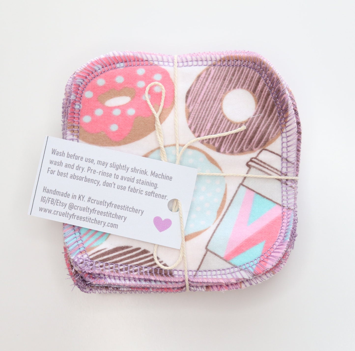 Bundled pack of donuts print cotton rounds with the back of the tag showing.